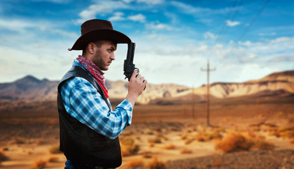 Cowboy with revolver, gunfight in gesert valley