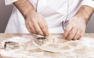 male cook preparing Christmas cookies