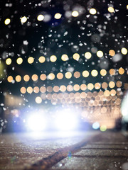 Slippery streets: Defocused car driving on snowy street with christmas decoration - 239052472