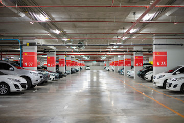 Blurred image/ Parking garage - interior shot of multi-story car park, underground parking with...