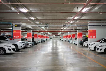 Fototapeten Blurred image/ Parking garage - interior shot of multi-story car park, underground parking with cars. © naruecha