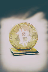 Golden bitcoin on a computer processor. There is a place for text. there is toning