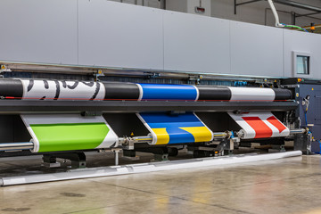 Very big printer during color sample phase, massive vinyl rolls, digital press technology, out of...