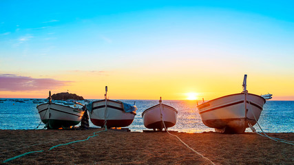 Fishing boats in the Mediterranean Sea on sunrise background