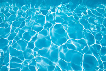 background blue transparent water of swimming pool, vibrating with ripples