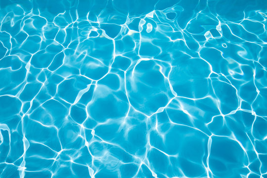 Background Blue Transparent Water Of Swimming Pool, Vibrating With Ripples