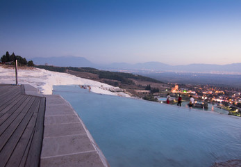 Fototapeta na wymiar Mineral water hot spring pools with tourists and bathers at Pamukkale Turkey