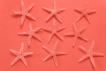 Fototapeta na wymiar Summer background of paper with starfish in color of the year 20