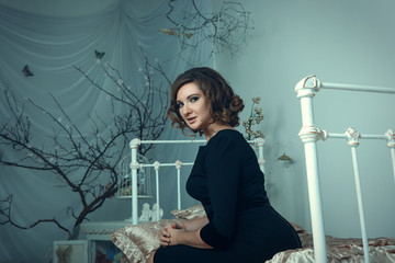 Beautiful model is posing in a dark studio