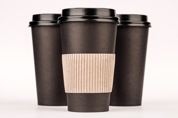 black paper cups on white background.