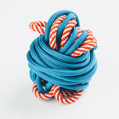 A bunch of blue-and-red rope lie on the white background