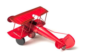 closeup of vintage metallic plane on white background