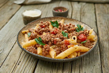 Bolognese pasta. Fusilli with tomato sauce, ground minced beef. Traditional italian cuisine. Side view.