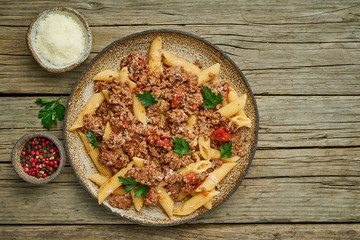 Bolognese pasta. Fusilli with tomato sauce, ground minced beef. Traditional italian cuisine. Top view, copy space