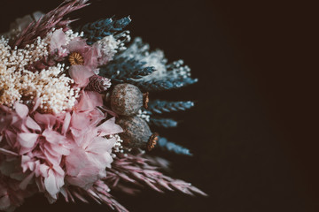 Close up of a rustic bridal bouquet on a dark background