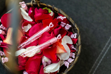 wicker basket with bubbles and rose petals