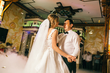 Fototapeta premium First wedding dance of newlywed. Bride and groom dancing first dance. Fireworks around.