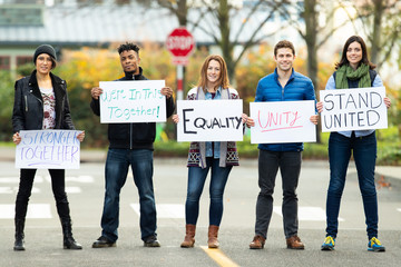 Group of protesters holding a sign  - Powered by Adobe