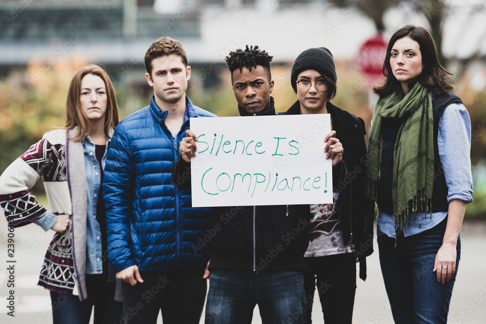 Wall mural Group of protesters holding a sign 