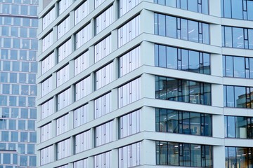 Obraz premium Facade fragment of a modern office building. Exterior of glass wall with abstract texture.