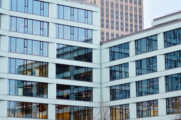Facade fragment of a modern office building. Exterior of glass wall with abstract texture.