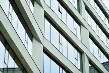 Facade fragment of a modern office building. Exterior of glass wall with abstract texture.