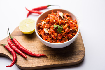 Hot and spicy Hot chilli chutney using lal mirch, cumin seeds, lemon juice and coriander. served in a bowl. selective focus