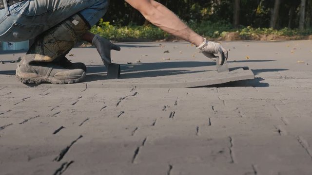Workers put markings on fresh concrete. Make a coating on the terrace