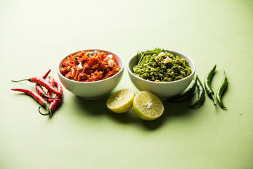 Hot and spicy Hot green and red chilli chutney using lal and hari mirch, cumin seeds, lemon juice and coriander. served in a bowl. selective focus