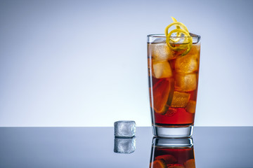 Coke cocktail with ice and lemon, alcohol bar