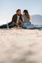 Beautiful couple enjoying picnic day on the beach