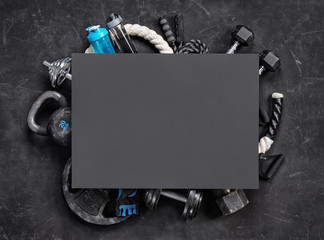 Sports equipment with board for copy space on a black background. Top view. Motivation