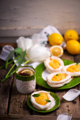 egg shaped meringue nests with lemon curd.traditional easter pastries.