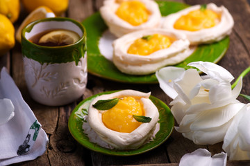 egg shaped meringue nests with lemon curd.traditional easter pastries.