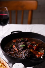 Beef cheeks in red wine with carrots and potato gratin.