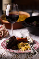 Beef cheeks in red wine with carrots and potato gratin.