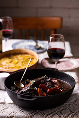 Beef cheeks in red wine with carrots and potato gratin.