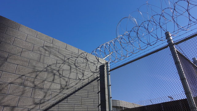 Barbed wire on top of border wall