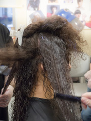 Hair straightening procedure. Close up.