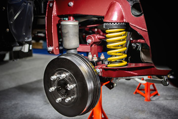 Front disc brake system on race car and detail of a wheel hub