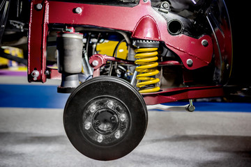 Front disc brake system on race car and detail of a wheel hub