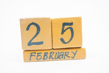 February 25th. Day 25 of month, handmade wood calendar isolated on white background. Winter month, day of the year concept.