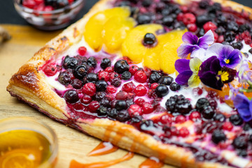 Delicious fruit tart with peach and berries