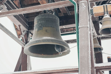 Obraz premium Large Church bell hanging outside. Close-up view of metal orthodox church bell.