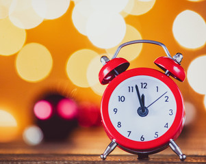 Vintage alarm clock and Christmas Lights on background