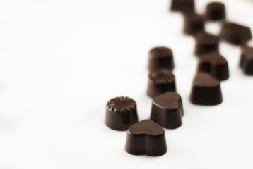 various chocolate pralines asorti on white bacground