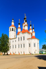 Fototapeta na wymiar Russian white orthodox Temple of the Entry of the Lord into Jerusalem against the blue sky The Nativity Church, Totma, Russia. Architectural forms reminiscent of a ship.