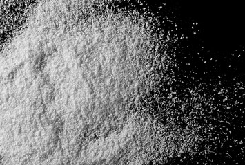 Pile of shredded coconut meat isolated on black background, top view