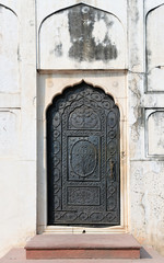 The bronze main door of the Moti Masjid mosque in Red Fort complex in New Delhi, decorated with floral decoration.