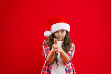 Christmas shopping. Little girl child in santa hat. Present for Xmas. Childhood. New year party. Santa claus kid. Happy winter holidays. Small girl. killing with hand gun